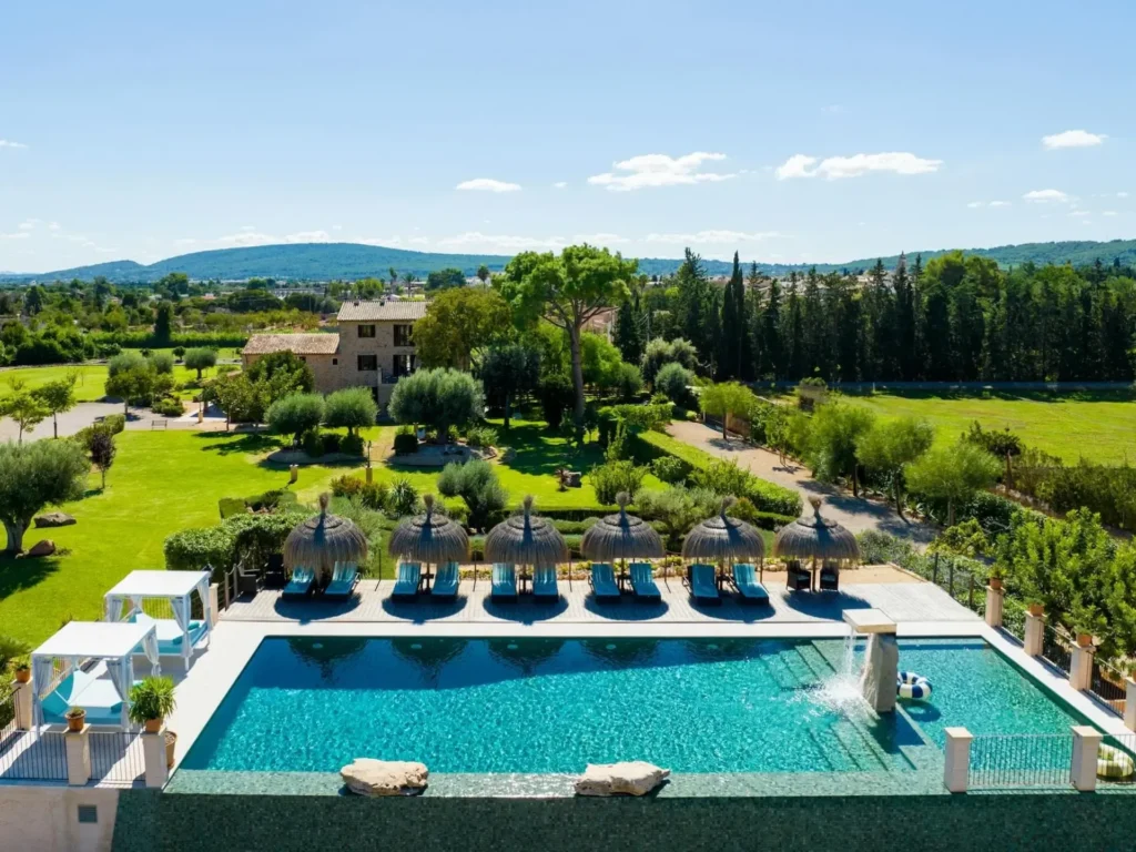Private swimming pool with sun loungers at Cas Metge Matas luxury villa in Santa Maria del Cami Mallorca