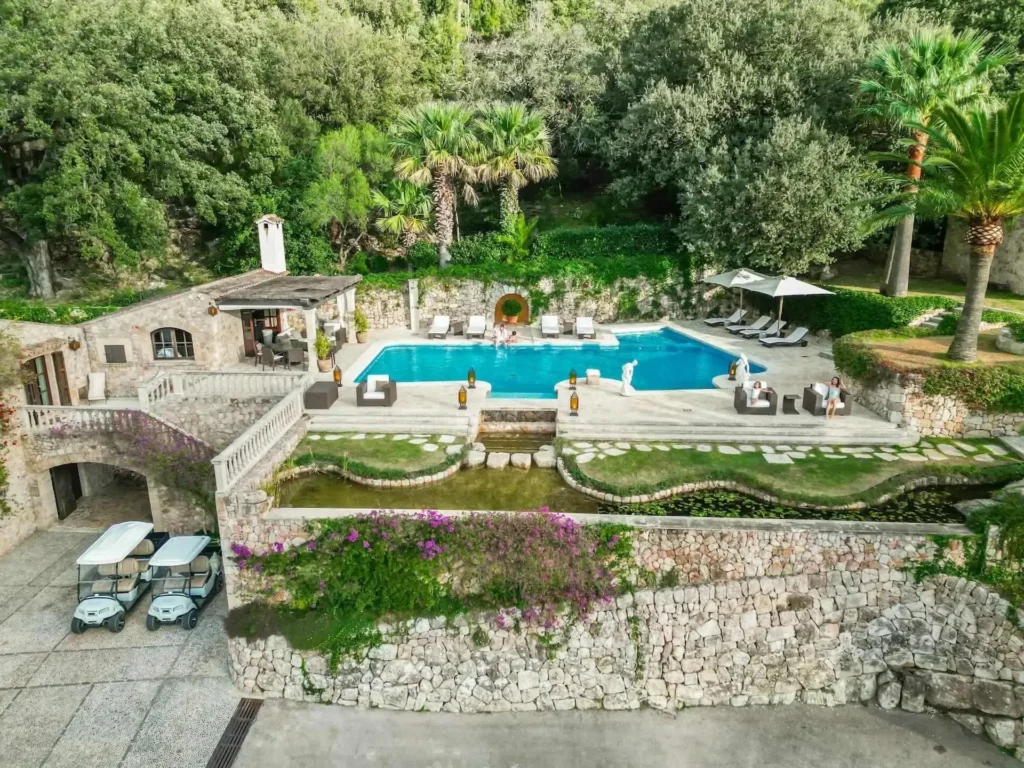 Swimming pool surrounded by gardens at Almond Valley estate in Pollença Mallorca